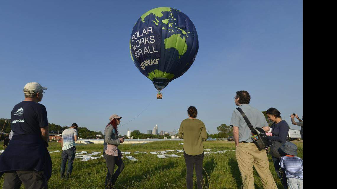 
Greenpeace flew a tethered, earth-shaped "Duke Don't Block Solar" hot air balloon Tuesday morning, May 5, 2015, from a staging area on North Davidson Street in Charlotte, in advance of Thursday's annual Duke Energy shareholder meeting in uptown. The other side of the balloon says, “Solar Works For All.”
