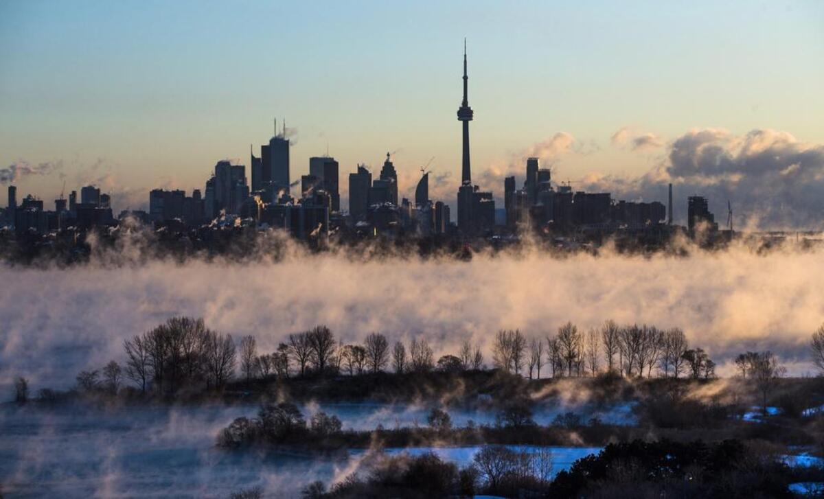 Mist rises from Lake Ontario in front of the Toronto skyline during extreme cold weather on Saturday, Feb. 13, 2016.