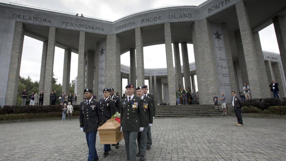 Soldiers of the U.S. and Belgian Army carry the coffin of Augusta Chiwy during a memorial service at the Mardasson Memorial in Bastogne, Belgium on Saturday, Aug. 29, 2015. Augusta Chiwy, 94, a Belgian nurse who helped save hundreds of American soldiers during the Battle of the Bulge at the end of World War II, was buried Saturday near where thousands of Allied troops fell. (AP Photo/Virginia Mayo)