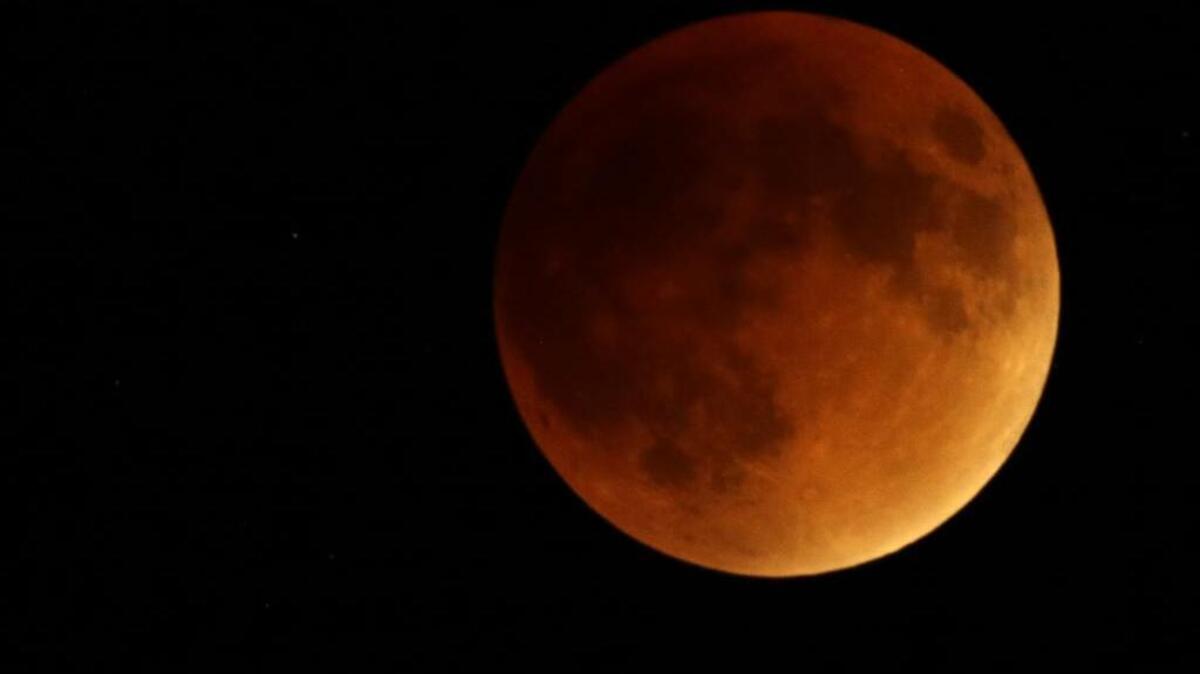 Earth’s shadow obscures the view of a so-called supermoon during a total lunar eclipse Sunday, Sept. 27, 2015, near Lecompton, Kan. It was the first time Sunday that the events have made a twin appearance since 1982, and they won’t again until 2033. (AP Photo/Orlin Wagner)
