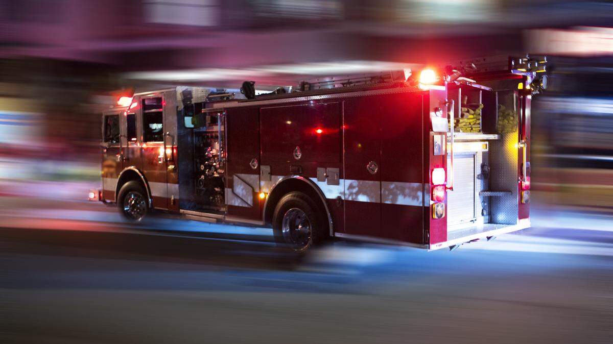 A driver ran over a fire hose, injuring a Los Angeles firefighter battling an early-morning blaze, California officials say.