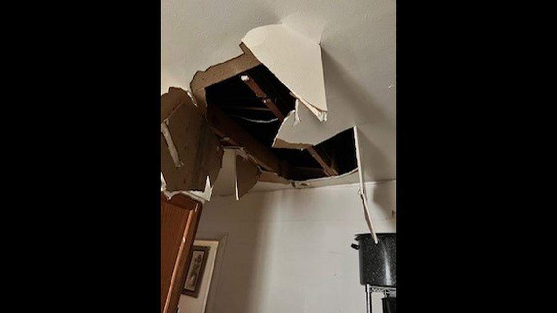 A man wanted on a murder charge crashed through the ceiling of a Tennessee home while law enforcement was searching the residence, officials said.