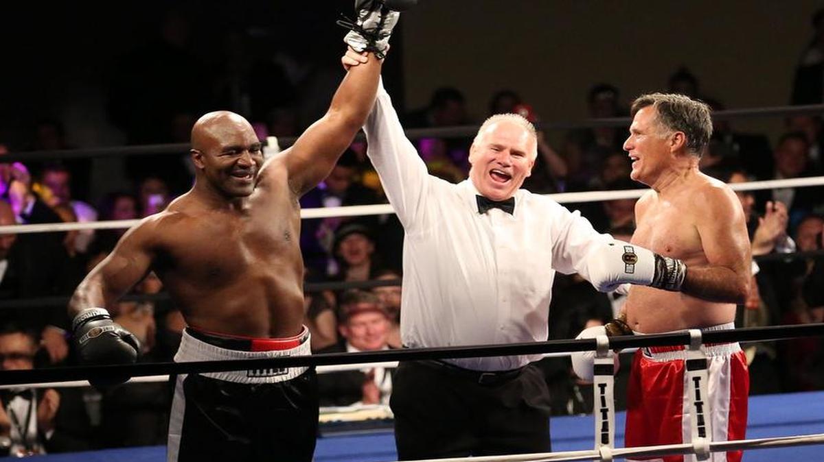 
Five-time heavyweight boxing champion Evander Holyfield, left, is declared the winner against Former Republican presidential candidate Mitt Romney during a charity fight night event Friday, May 15, 2015, in Salt Lake City. The black-tie event raised money for the Utah-based organization CharityVision, which helps doctors in developing countries perform surgeries to restore vision in people with curable blindness. (Kristin Murphy/Deseret News via AP) 
