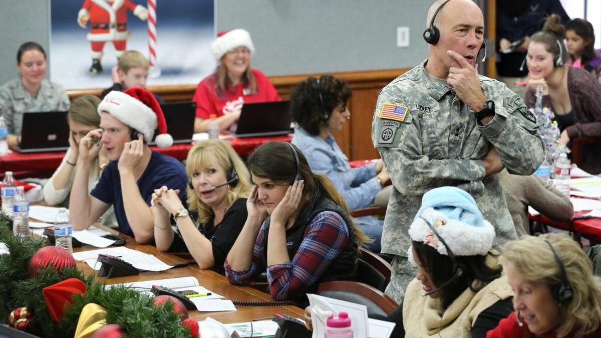 In this Dec. 24, 2014, file photo, NORAD and U.S. Northern Command Chief of Staff Maj. Gen. Charles D. Luckey joins other volunteers taking phone calls from children around the world asking where Santa is and when he will deliver presents to their homes.