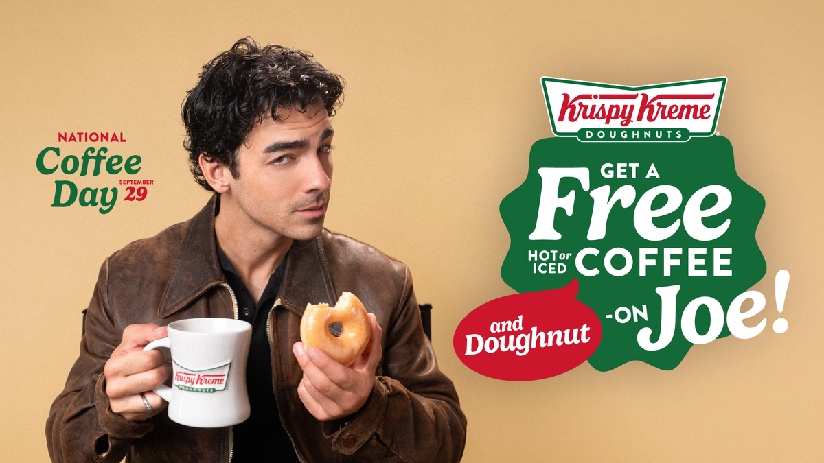 A publicity photo of singer Joe Jonas holding a Krispy Kreme mug and a partially eaten doughnut. The image also includes the Krispy Kreme logo and a promotional message that says “National Coffee Day, September 29,” and “Get a Free Hot or Iced Coffee and Doughnut - on Joe!”