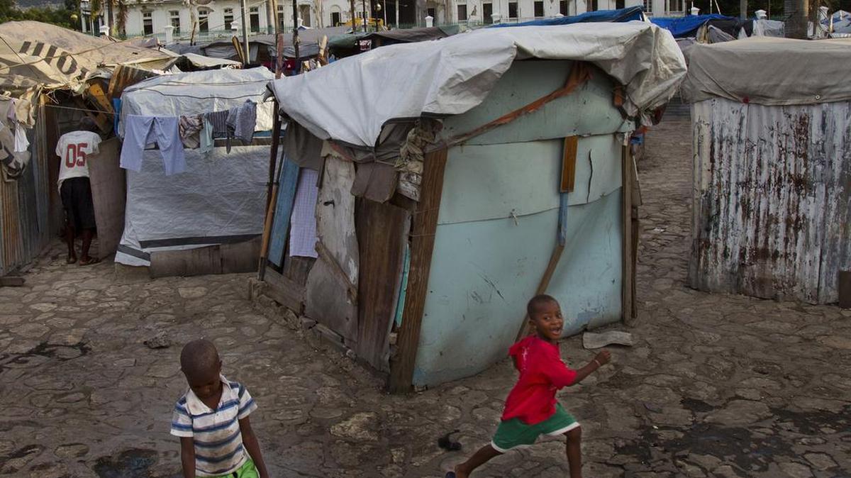 Youngsters play near their family’s makeshift homes in Port-au-Prince, Haiti, August 15, 2011. On Monday, a Mennonite missionary from Virginia was sentenced to 23 years in prison for sex crimes against children in remote villages in Haiti.