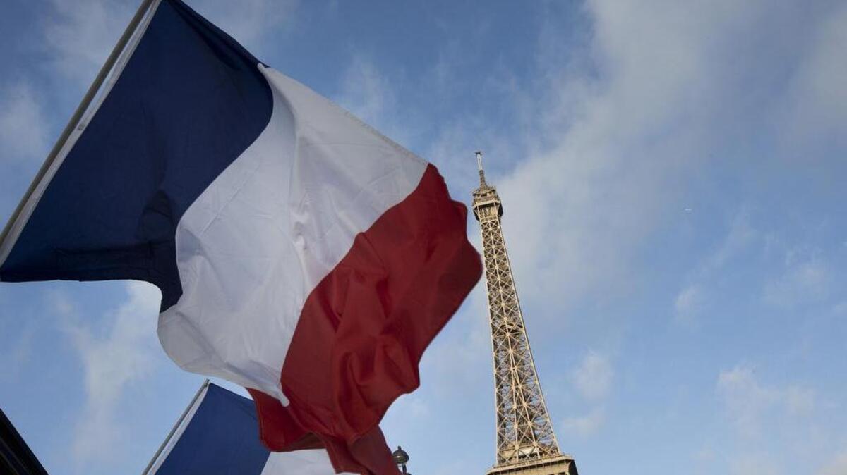 French flags flay near the Eiffel Tower on Nov. 15, 2015. (AP Photo/Peter Dejong)