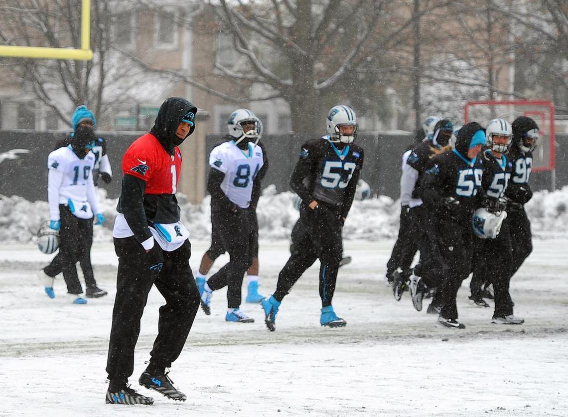 Carolina Panthers quarterback Cam Newton, left, walks across a practice field covered in snow and ice, Friday, Jan. 22, 2016, in Charlotte, N.C. That snowy practice, two days before the Panthers whipped Arizona 49-15 in the NFC championship game, was among Ron Rivera's favorite memories at Carolina.