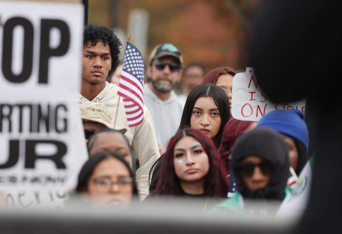 Protesters listen to speakers at the No Border Patrol protest Saturday, Nov. 15, 2025 in uptown Charlotte.