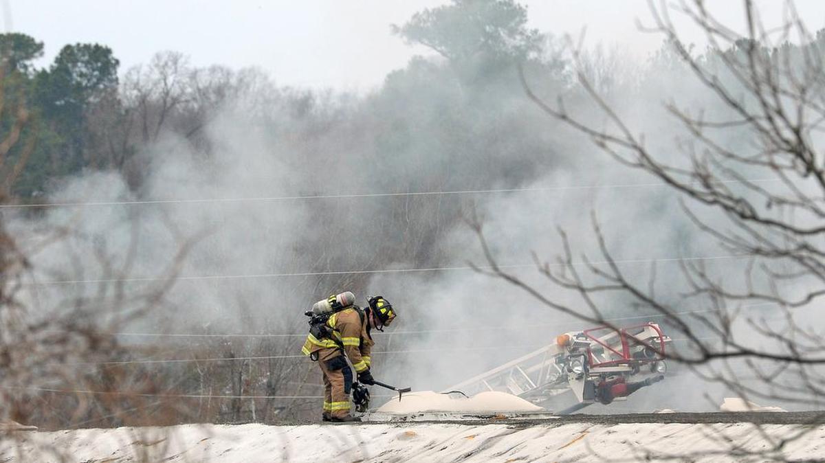 A Raleigh firefighter vents the roof at Recycling Management Services on S. Blount St. in Raleigh. The fire involved a bundle of recyclable material and caused a second alarm to be called Dec. 27, 2016. About 12-15 workers were evacuated and there were no injuries reported.