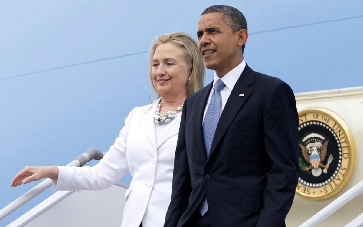 In this Nov. 19, 2012, file photo, President Barack Obama and then-Secretary of State Hillary Clinton arrive at Yangon International Airport in Yangon, Myanmar, on Air Force One.