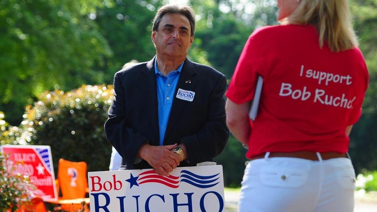 North Carolina State Senator Bob Rucho listens to campaign worker Michele Hutchens outside Precinct 75 at Holy Covenant UCC in Charlotte, NC on Tuesday, May 6, 2014.