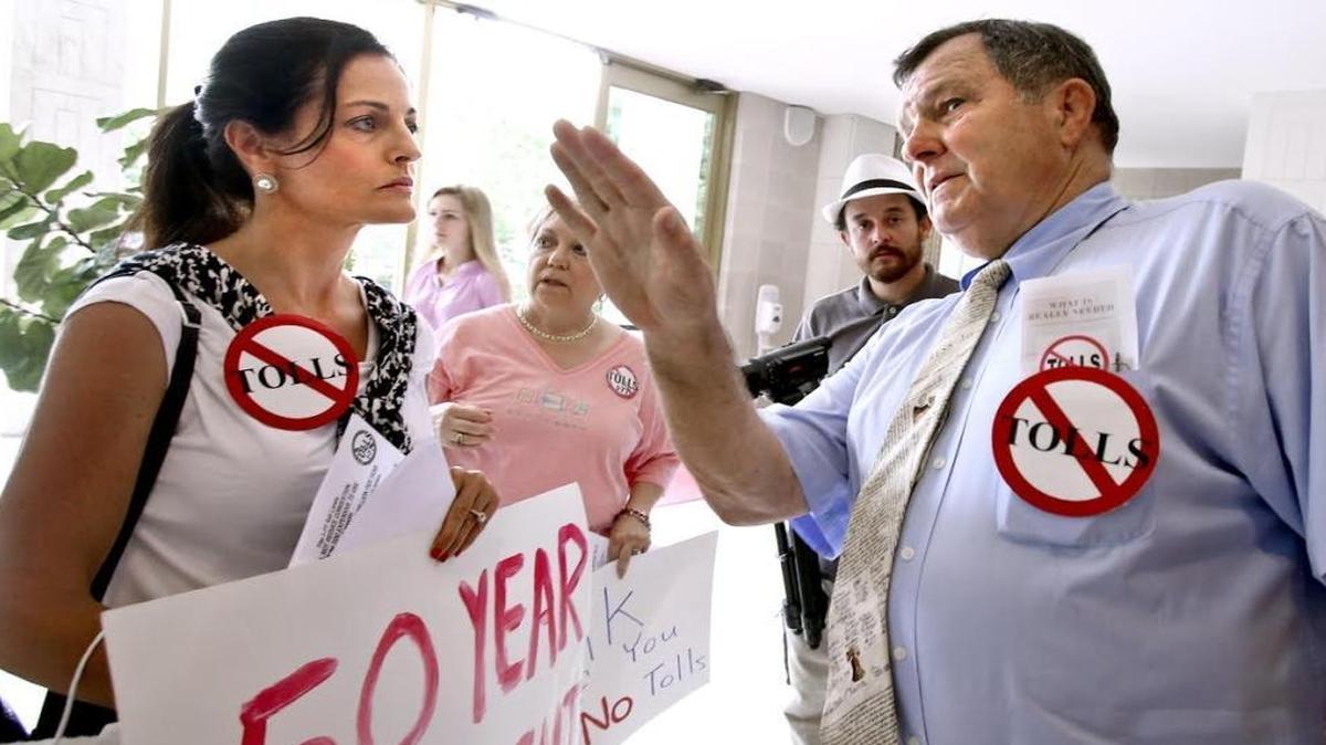 Opponents of the I-77 tolls, like Vallee Bubak, left, and former Rep. Robert Brawley, right, strategize how to best distribute their materials to lawmakers inside the N.C. General Assembly on Tuesday, May 26, 2015.