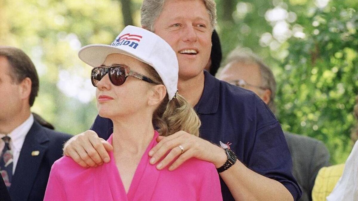 In 1992, then-Democratic presidential nominee Bill Clinton stands with his wife Hillary Clinton during a campaign stop in Carrollton, Ky. Bill Clinton promised voters then that they would be getting two for the price of one if they elected him to the White House, a presidential duo of the young Arkansas governor and his Yale Law-educated wife.