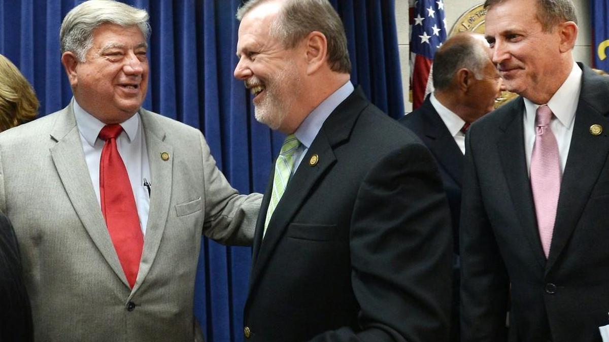 Sen. Bill Cook, left, congratulates Senate leader Phil Berger, center, as he and Majority Leader Sen. Harry Brown, right, leave a press conference at the N.C. Legislature where they announced the highlights of their budget Tuesday, May 31, 2016.