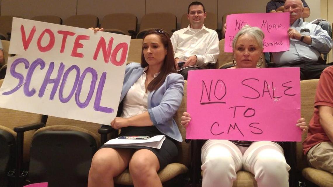 Bobbi Almond (right) and Gretchen Caldwell protested the City Council's decision Monday to sell 11.4 acres of the old Eastland Mall site to CMS for a K-8 school.