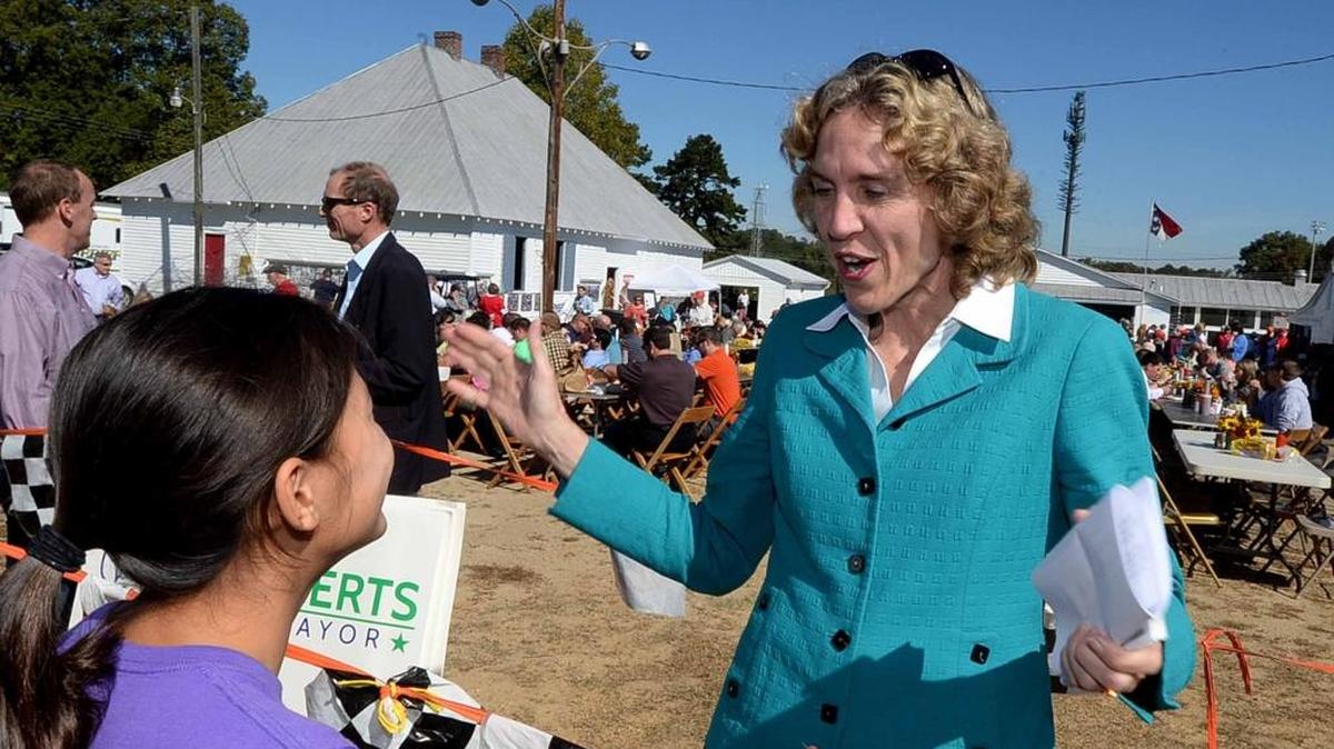 Democratic Mayoral candidate Jennifer Roberts greets Kara Parker, 11, left, at the annual Mallard Creek BBQ event at Mallard Creek Presbyterian Church, which feed folks' need for pulled pork, Brunswick stew and politicians.
