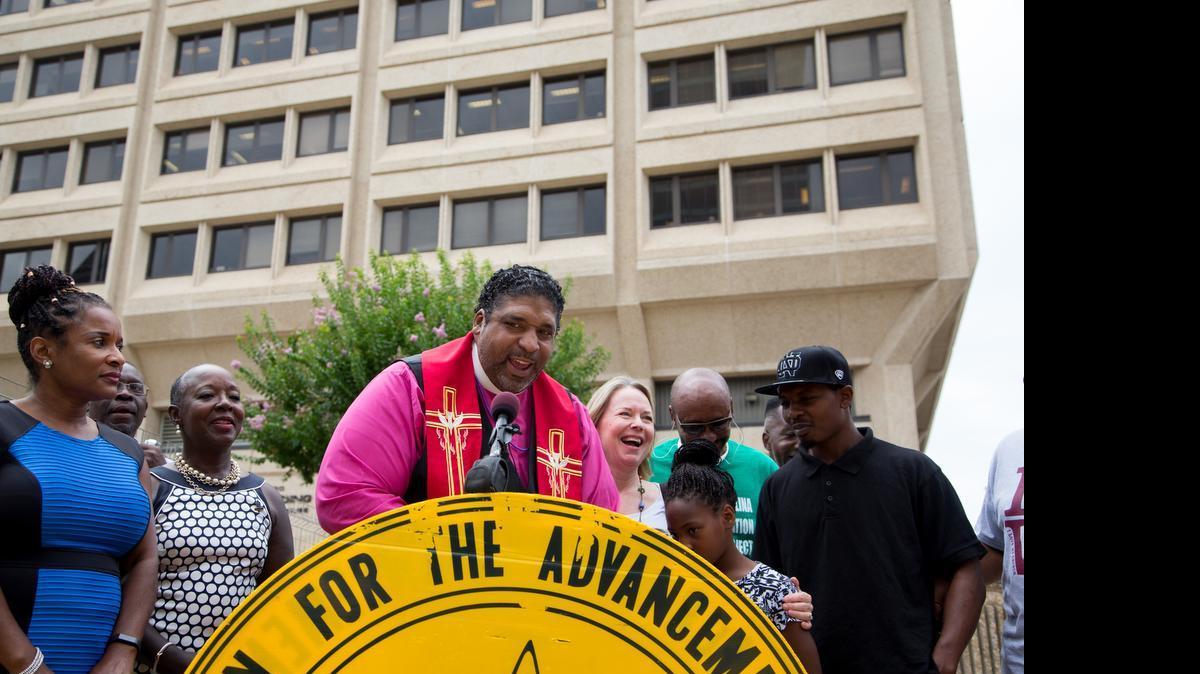 
William Barber II, president of the North Carolina NAACP, discusses a legal challenge to state election law outside a federal courthouse in Winston-Salem, N.C., July 8, 2015. 
