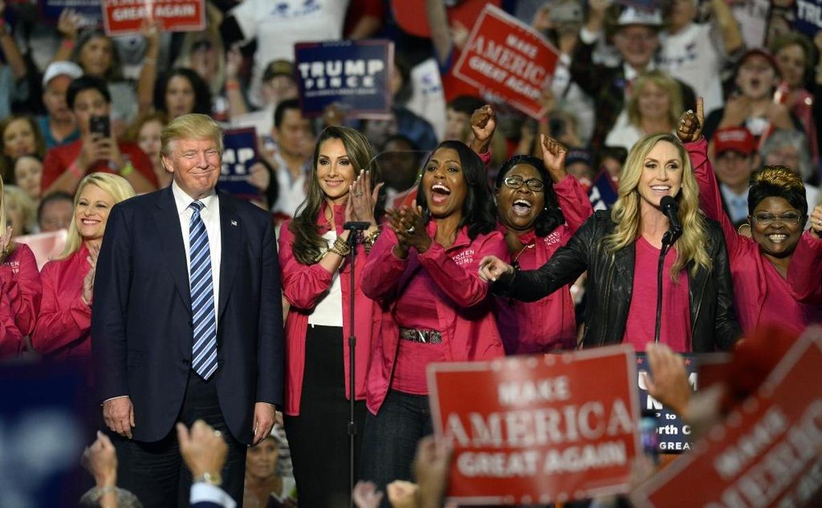 Daughter-in-law Lara Trump, right, speaks to the crowd as other members of Women for Trump stand beside Republican presidential candidate Donald Trump during a campaign rally at the Charlotte Convention Center in Charlotte on Friday, Oct. 14, 2016.
