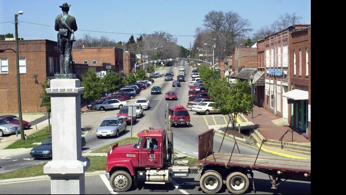 
A statue of a Confederate solder looks north on Hillsboro Street from the traffic circle of downtown Pittsboro, NC. 
