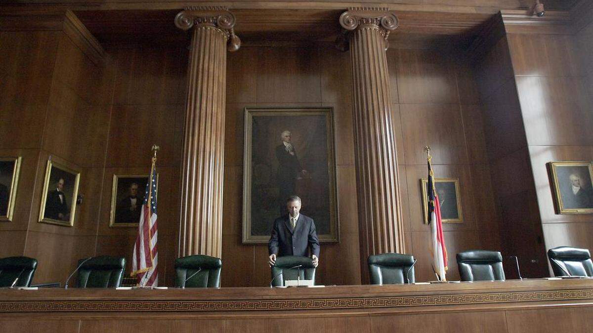 Court historian Danny Moody straightens the Chief Justice’s chair in the chambers of the Supreme Court of North Carolina at the Law and Justice Building in downtown Raleigh.