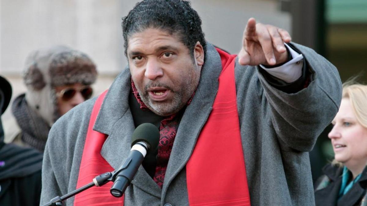 Rev. William Barber urges HKonJ march protesters to both donate to the cause and get in their march groups at the end of the rally portion in front of Memorial Auditorium in downtown Raleigh, NC Saturday morning, February 13, 2016.