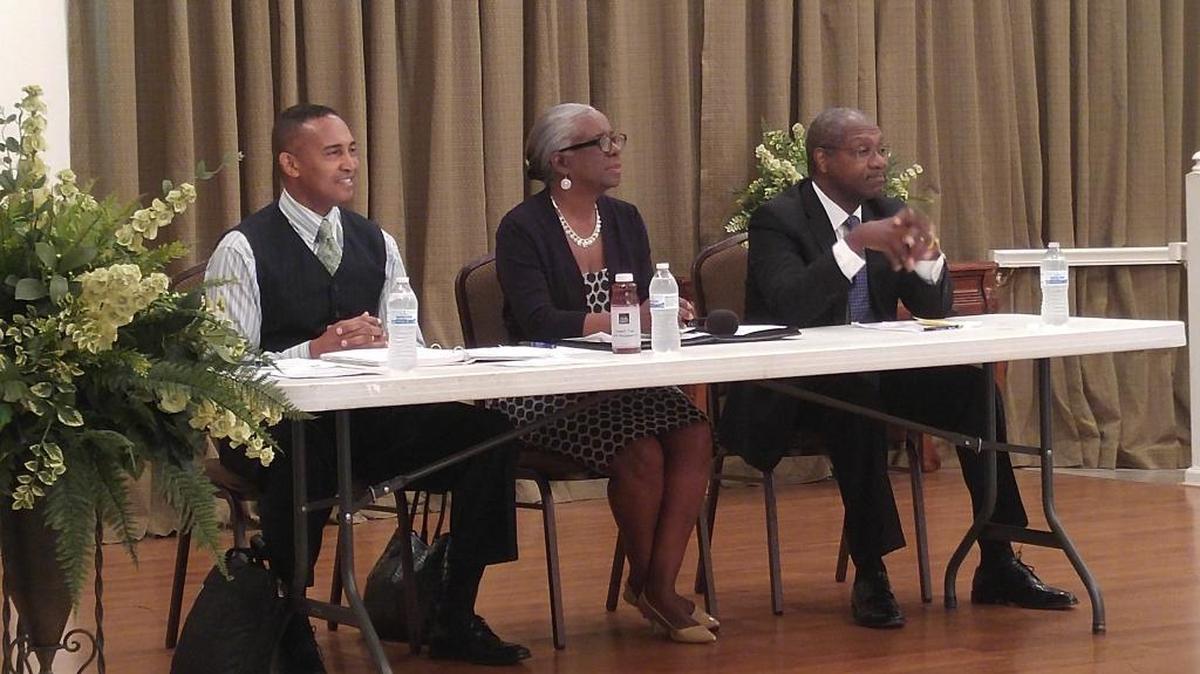 Former Charlotte Mayor Patrick Cannon (left) spoke at a Black Political Caucus Forum Saturday. When asked by reporters whether he plans to run for office again, Cannon said he wants to focus on his family. He said “anything else is God’s will.”