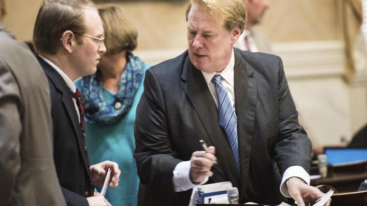 State Rep. Rick Quinn, R-Lexington, right, signs paperwork in the House chamber at the South Carolina Statehouse in Columbia, S.C. in January. The state grand jury has indicted Quinn on two counts of misconduct in office, prosecutor David Pascoe announced Tuesday.