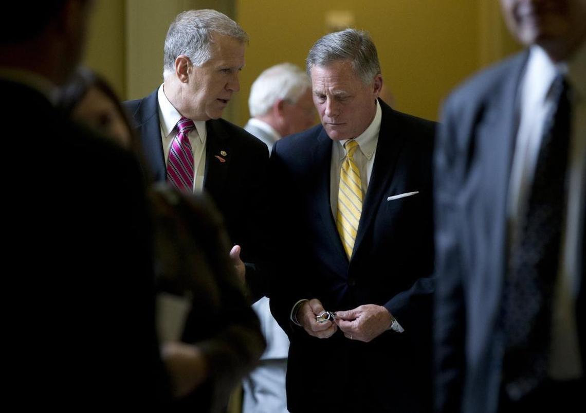 Sen. Thom Tillis, R-N.C., left, and Sen. Richard Burr, R-N.C., right, walk on Capitol Hill.