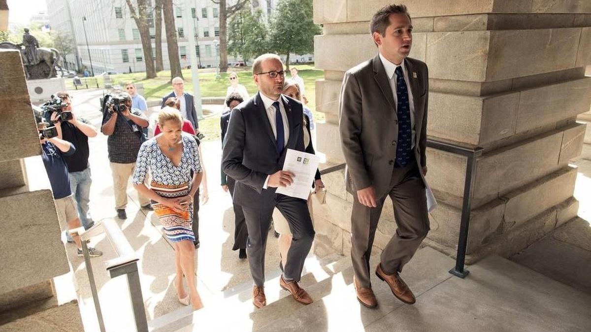 From left, Candis Cox, Chad Griffin, president of the Human Rights Campaign and Chris Sgro, with Equality NC walk Thursday, March 31, 2016 up the NC State Capitol steps in Raleigh to deliver a letter signed by hundreds of companies to Gov. Pat McCrory asking for the repeal of House Bill 2 that was recently passed by the NC legislature.