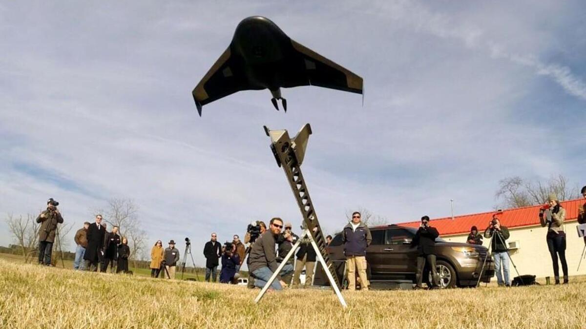 
A Janurary photo shows Trimble applications engineer Chip Berniard launches a $50,000 unmanned aerial vehicle designed for agriculture and research applications during a demonstration Thursday, January 29, 2015 on farm land owned by N.C. State University. The drone can record data that can be used to make detailed three-dimensional maps and is capable of determining things such as how much nitrogen should be added to parts of a field or where weeds or disease are encroaching on crops. 
