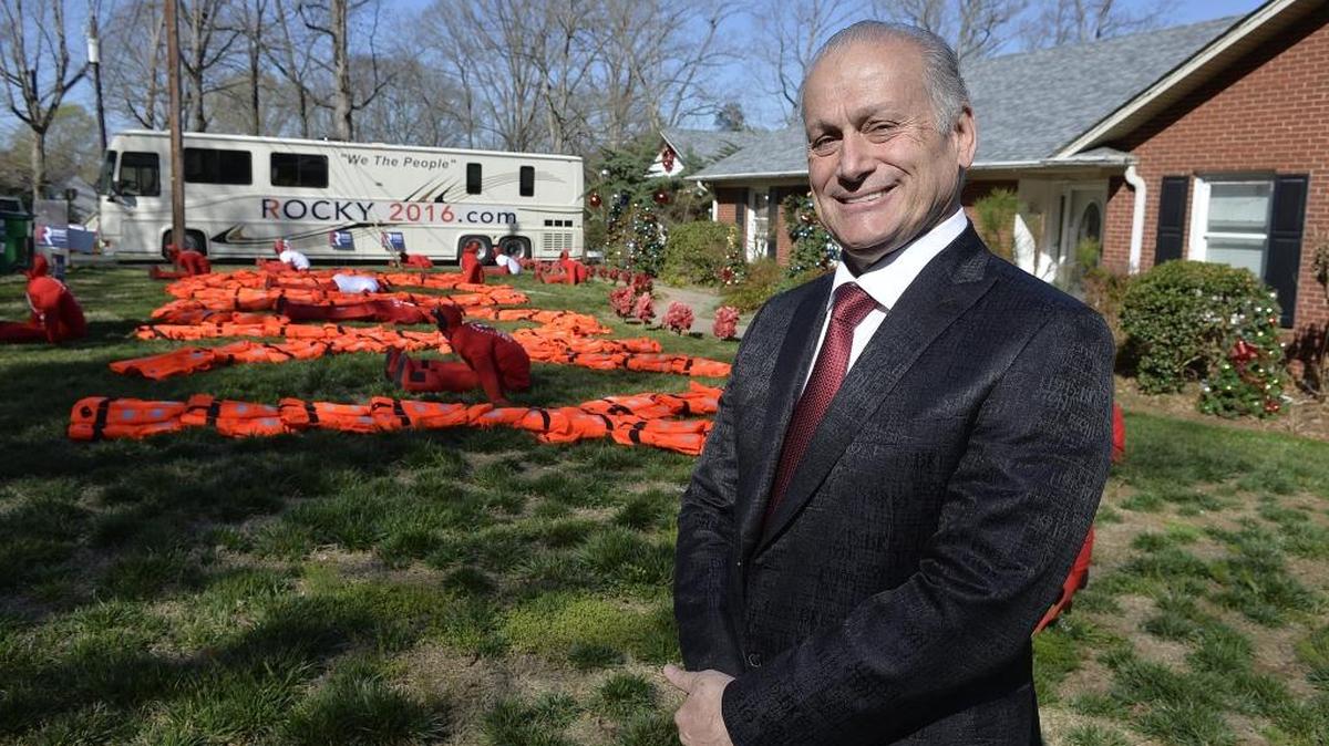 Roque “Rocky” De La Fuente in front of a rented house he uses while campaigning in Charlotte, NC. De La Fuentes is running for president. He's rented a house on Lake Wyile, which he's surrounded with huge campaign buses, stuffed manikins, Christmas decorations and other stuff. De La Fuente is a wealthy California businessman who has managed to get on the ballot in NC and other states.