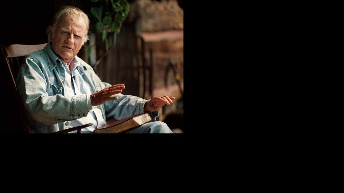 
The Rev. Billy Graham speaks from his front porch during a 1996 press conference at his home in Montreat.
