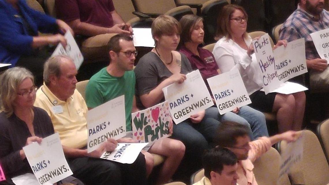Supporters of funding parks and greenways rather than a new soccer stadium attend Wednesday’s meeting of the Mecklenburg County commissioners.