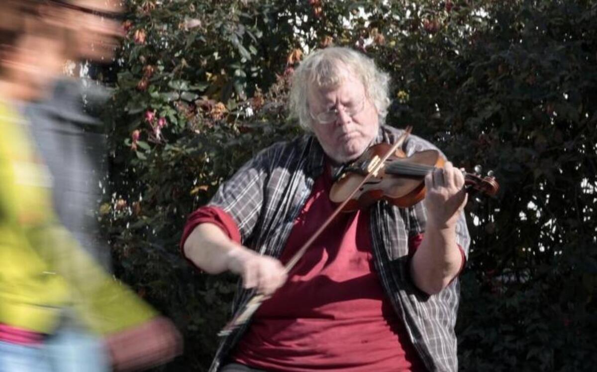 Street fiddler David McKnight plays tunes for passersby on a sunny December afternoon in 2013 on Ninth Street in downtown Durham. McKnight died Tuesday of a brain tumor.