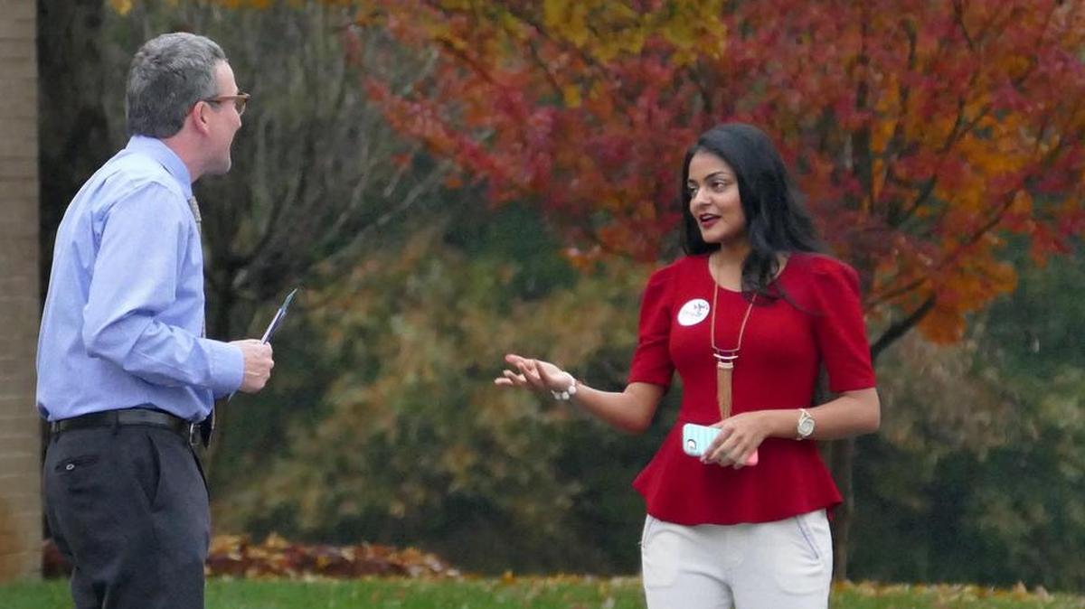 City Council at-large candidate Dimple Ajmera greets voters outside the Oasis Shrine Temple on Doug Mayes Place early Tuesday morning.