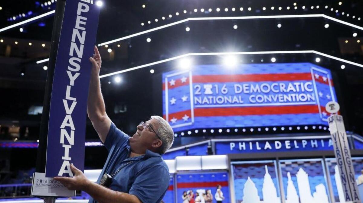 Jimmy Wright installs the Pennsylvania delegation placard ahead of the 2016 Democratic National Convention in Philadelphia, Sunday, July 24, 2016.
