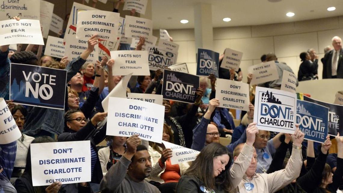 
Supporters and opposition to the proposed non-discrimination ordinance hold up signs inside the Charlotte Mecklenburg Government Center prior to the start of the Charlotte City Council on Monday, March 2, 2015.
