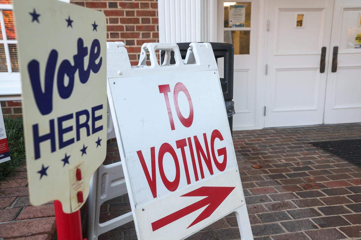 Signs are outside Providence Baptist Church, indicating where voters can enter precinct 36 and cast their ballot for the election in Charlotte on Tuesday.