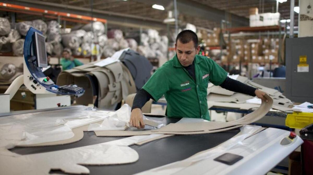 Marcos Godoy of Mexico City manufactures car dash mats in Ciudad Juarez, Mexico, on Dec. 27, 2013. Donald Trump and Hillary Clinton both want to make changes to trade agreements to bring jobs back to the United States, but experts say those changes could put additional pressure on North Carolina industries that have already suffered from recent international commerce pacts.