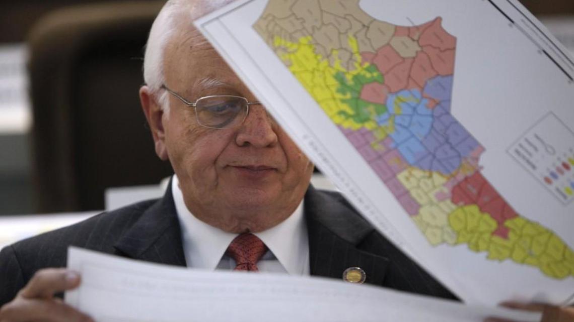 Rep. John Faircloth checks maps during a meeting of joint redistricting committees Monday, Nov. 7, 2011.