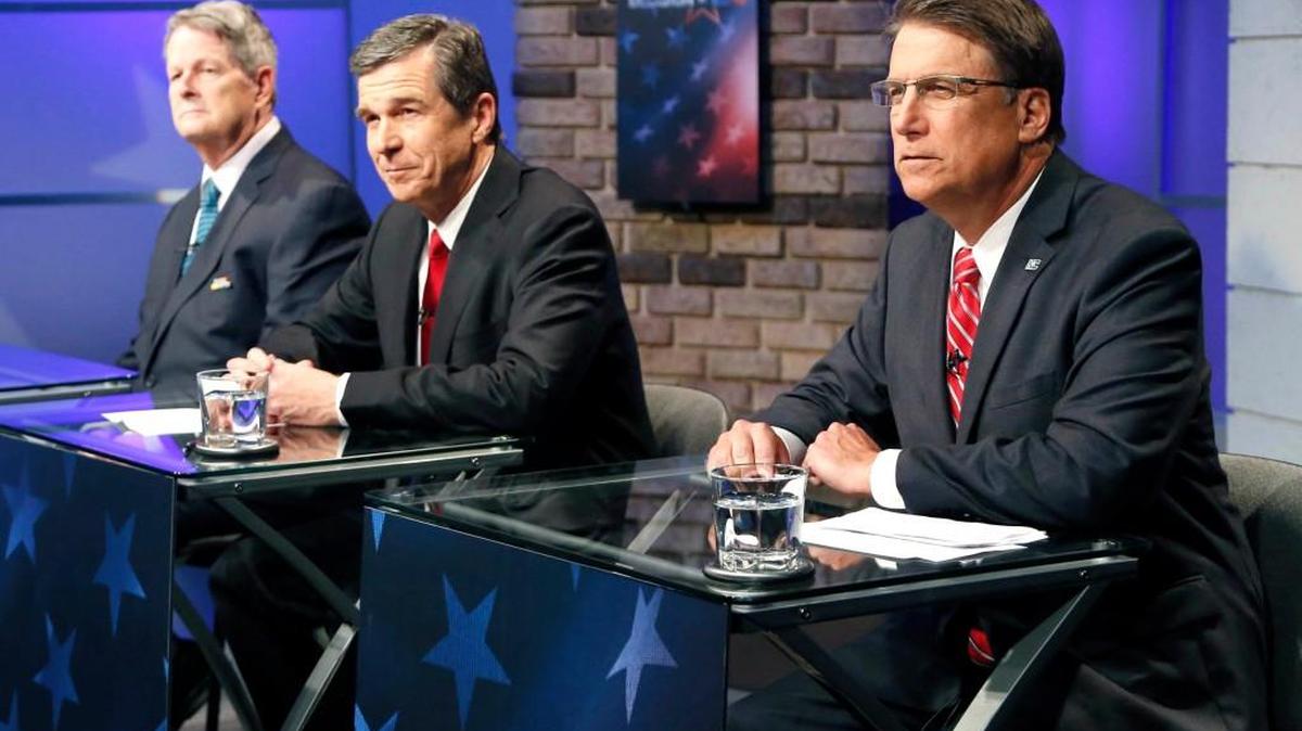 N.C. gubernatorial candidates Roy Cooper, center, and Gov. Pat McCrory debate at WRAL studios in Raleigh on Oct. 18, 2016. Lon Cecil sits to the left.