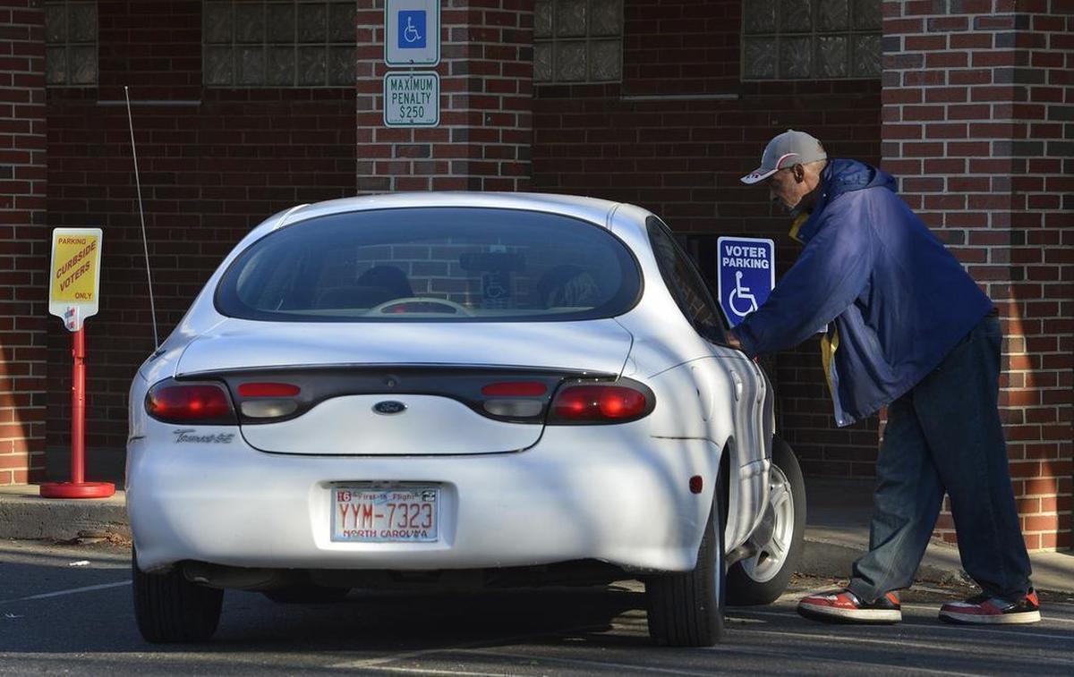 Precinct assistant Winfred Phillips assisting handicapped voters at West Charlotte High School Tuesday morning, March 15, 2016. North Carolina voters head to the polls today for primaries, including president, governor and the U.S. Senate. Polls in North Carolina opened at 6:30 a.m. and close at 7:30 p.m.