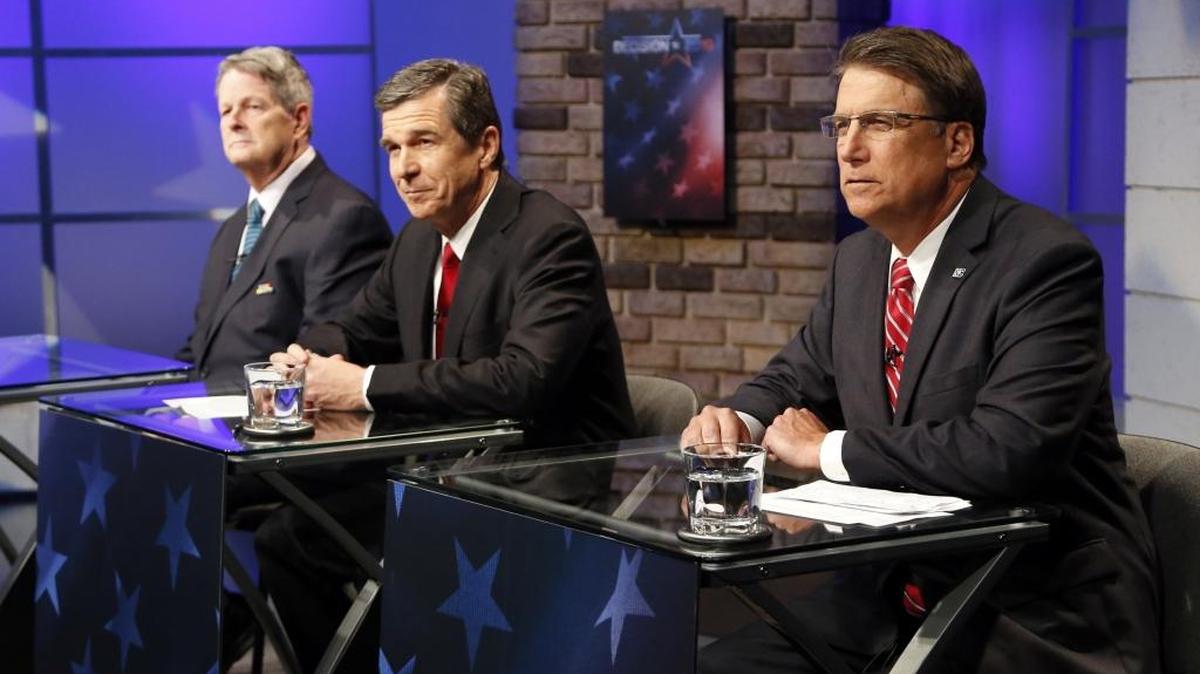 Candidates for governor of North Carolina Lon Cecil (L), left, Roy Cooper (D), center, and Gov. Pat McCrory (R) debate at WRAL studios in Raleigh NC on Oct. 18, 2016.