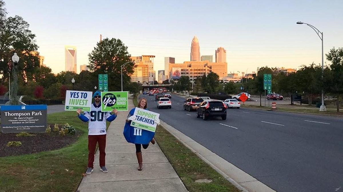 Volunteers in Halloween costumes displayed Vote Yes for School Bonds signs on Tuesday.
