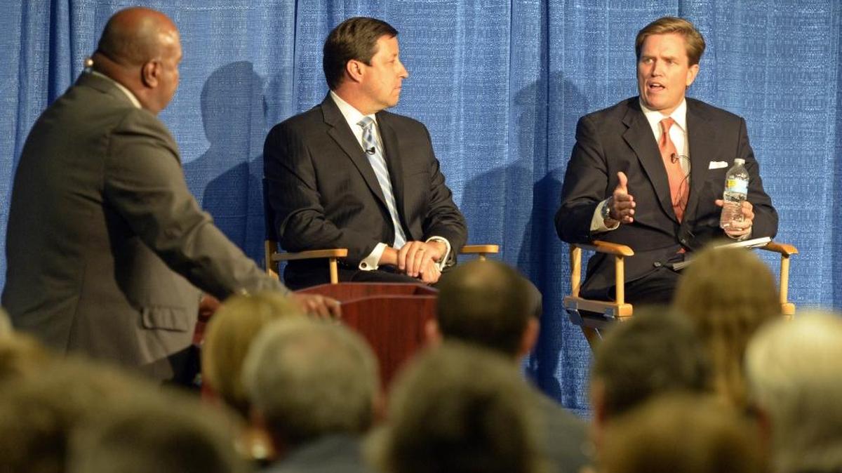 

Republican mayoral candidates Edwin Peacock, right, and Scott Stone, center, debate the street car, city budgets and police oversight Wednesday at Queens University of Charlotte. 


