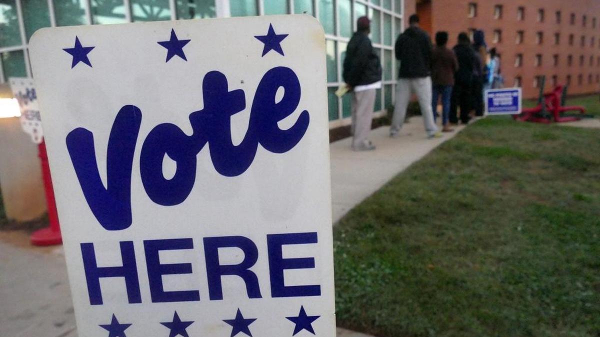Voters stand in line at the Beatties Ford Road Regional Library for early voting.