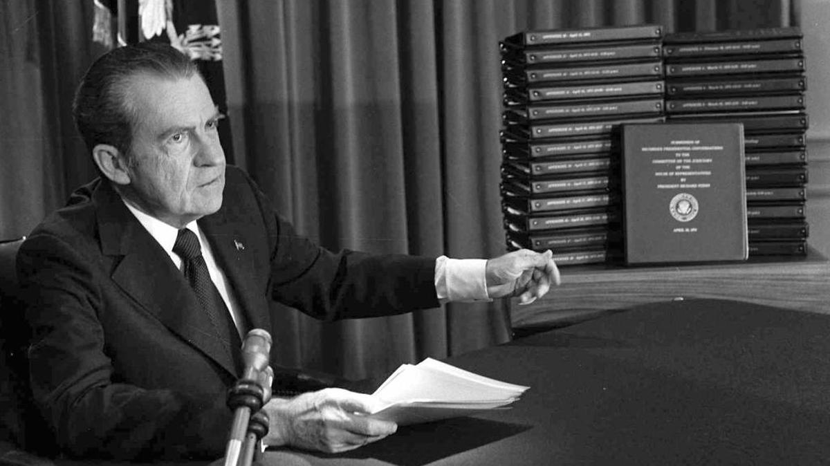 FILE - In this April 29, 1974, file photo, President Richard M. Nixon points to the transcripts of the White House tapes after he announced during a nationally-televised speech that he would turn over the transcripts to House impeachment investigators, in Washington. The last 340 hours of tapes from Nixon's White House were released Wednesday, Aug. 21, 2013, along with more than 140,000 pages of text materials.
