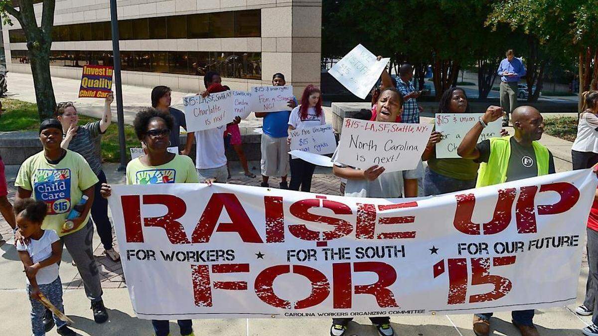 Workers rally outside the Charlotte-Mecklenburg Government Center Thursday, Sept.10, 2015, to demand a $15 hourly wage.