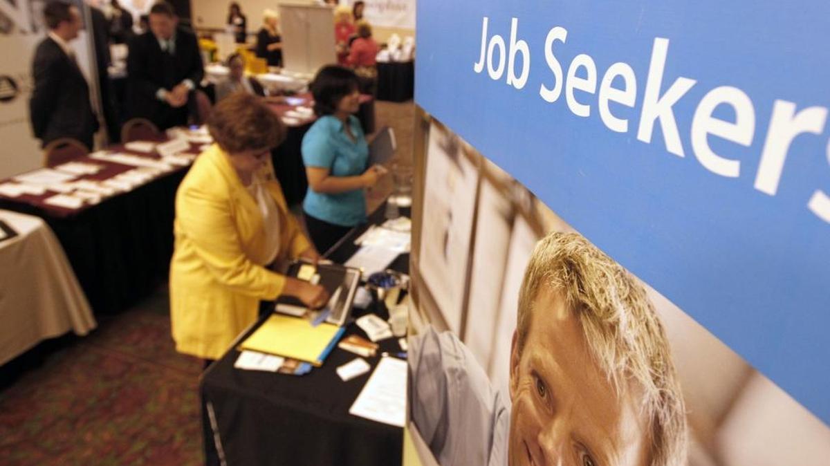People walk by the recruiters at a jobs fair in Green Tree, Pa., in 2012.